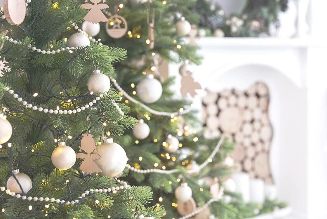 white and gold decorations on a christmas tree