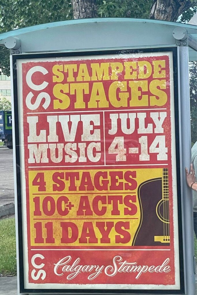 A poster promoting "Stampede Stages LIVE MUSIC JULY 4-14" at the Calgary Stampede, featuring 4 stages, 100+ acts over 11 days, in a bold red and yellow design with a guitar illustration.