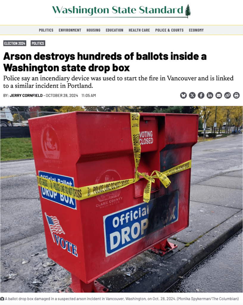 A screenshot of a news article from Washington State Standard reporting on an arson incident that destroyed ballots inside a Washington state drop box. The featured image shows a red official ballot drop box with police tape wrapped around it, visibly burned and damaged.