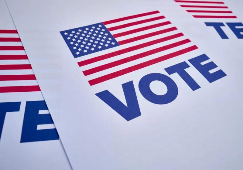 An American flag-themed flyer with the word "VOTE" in bold letters, encouraging participation in elections.