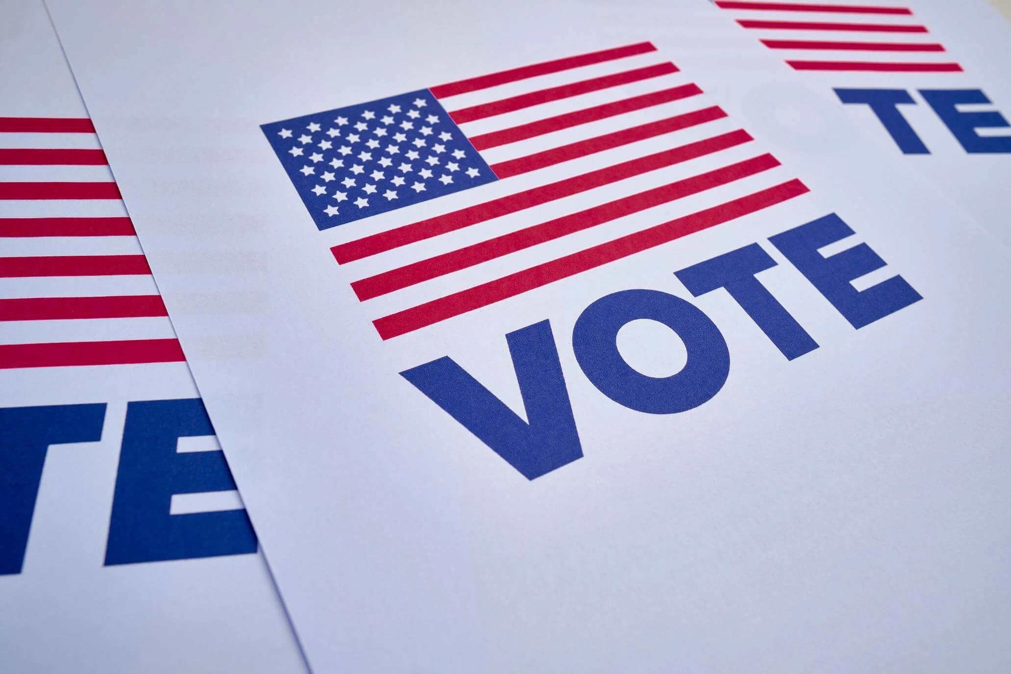 An American flag-themed flyer with the word "VOTE" in bold letters, encouraging participation in elections.
