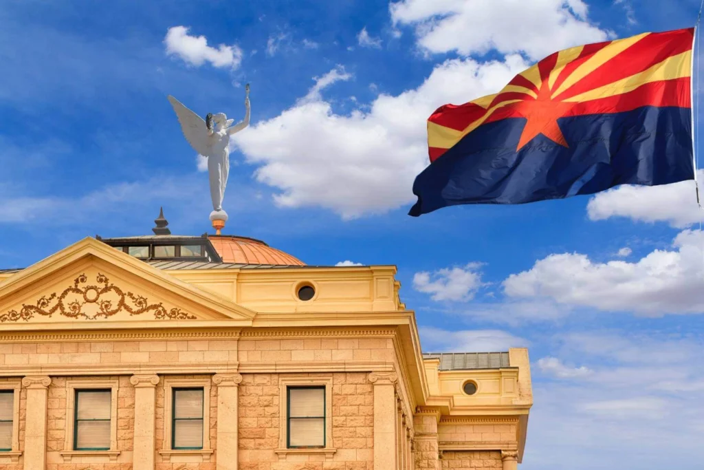 Arizona Capitol and state flag, symbolizing the financial consequences of political tourism boycotts on conservative U.S. states.