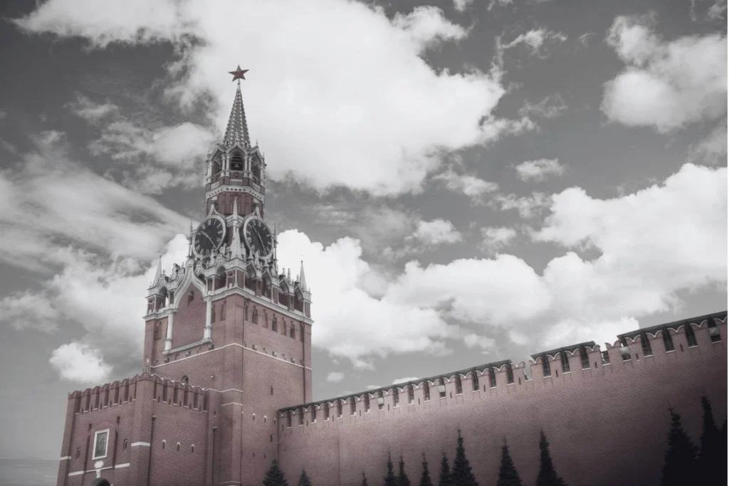Grey scaled close up view of the Kremlin in Moscow, Russia under a very cloudy sky.