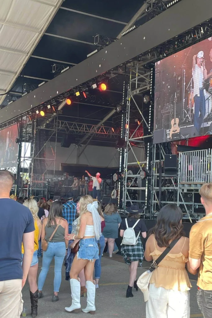 Daytime crowd watching live country music performance at Cowboys Music Festival in Calgary.