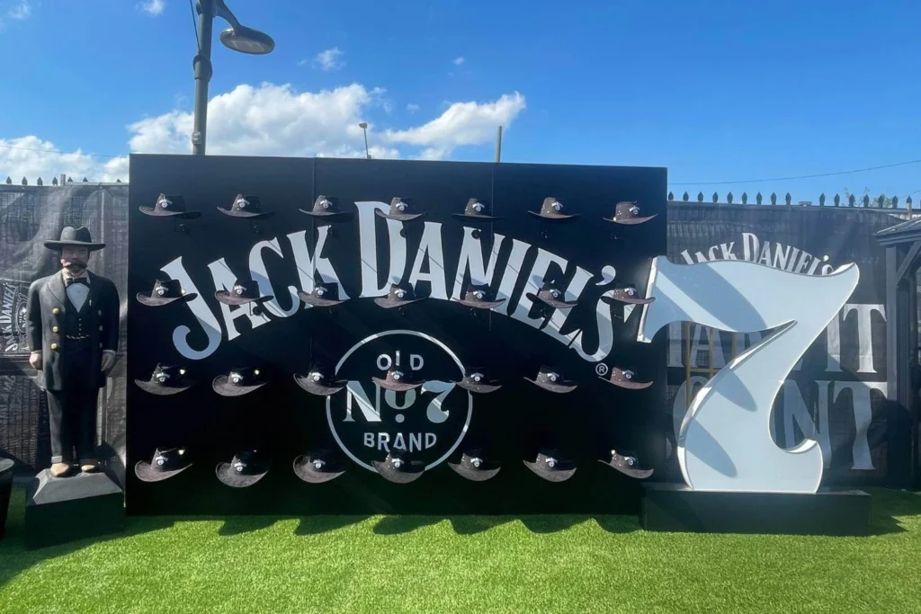 Jack Daniels Old No. 7 brand display with mini cowboy hats and life-sized statue at Cowboys Music Festival during Calgary Stampede.