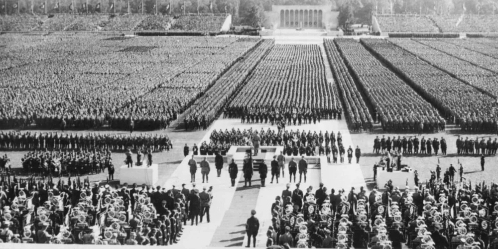 A massive Nazi rally in Nuremberg in the 1930s, showing thousands of soldiers and SS officers in formation during Hitler’s rise to authoritarian power.