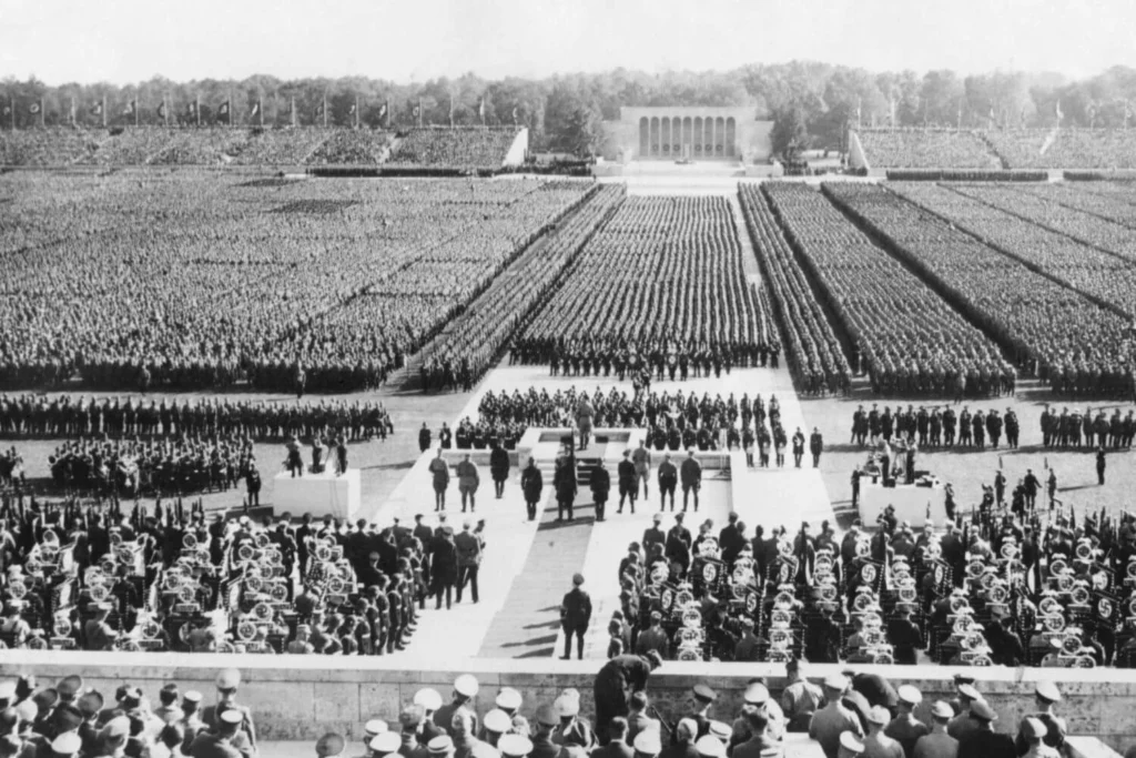 A massive Nazi rally in Nuremberg in the 1930s, showing thousands of soldiers and SS officers in formation during Hitler’s rise to authoritarian power.