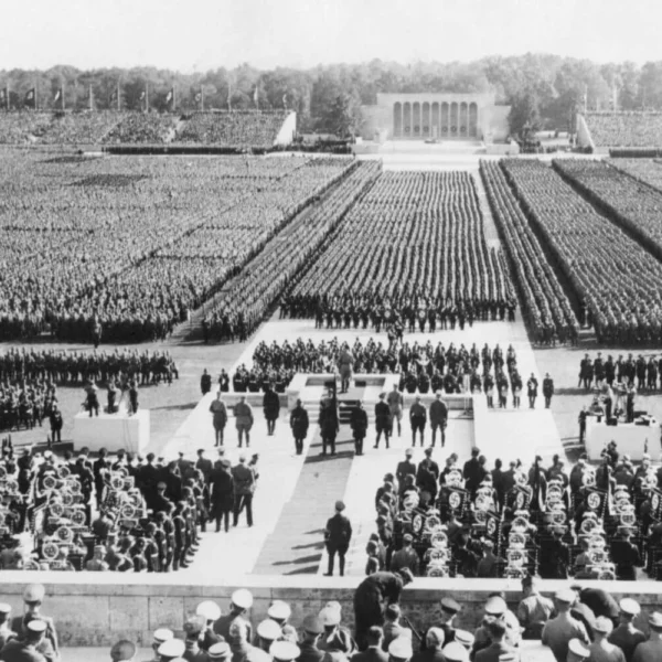 A massive Nazi rally in Nuremberg in the 1930s, showing thousands of soldiers and SS officers in formation during Hitler’s rise to authoritarian power.
