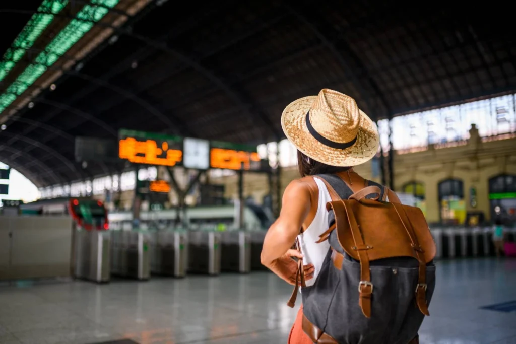 Confident female traveler preparing to board a train, representing thoughtful travel and the power of personal decision-making.