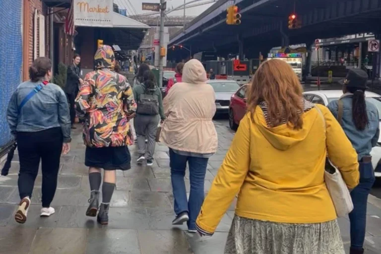 Women walking together in a city, symbolizing the collective influence of female travelers on local tourism.