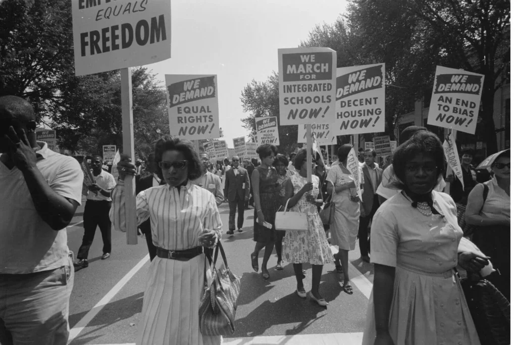 Civil rights activists marching in Washington, D.C. in 1963 holding signs demanding equal rights, integrated schools, and an end to racial bias. Image taken by Warren K. Leffler, 1963, and displayed in Library of Congress