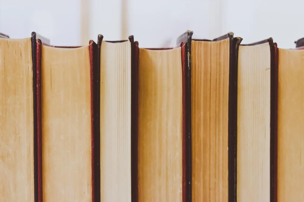 Close-up of stacked books symbolizing youth nonfiction on Hitler, WWII, and the Holocaust — teaching the dangers of authoritarianism and fascism.