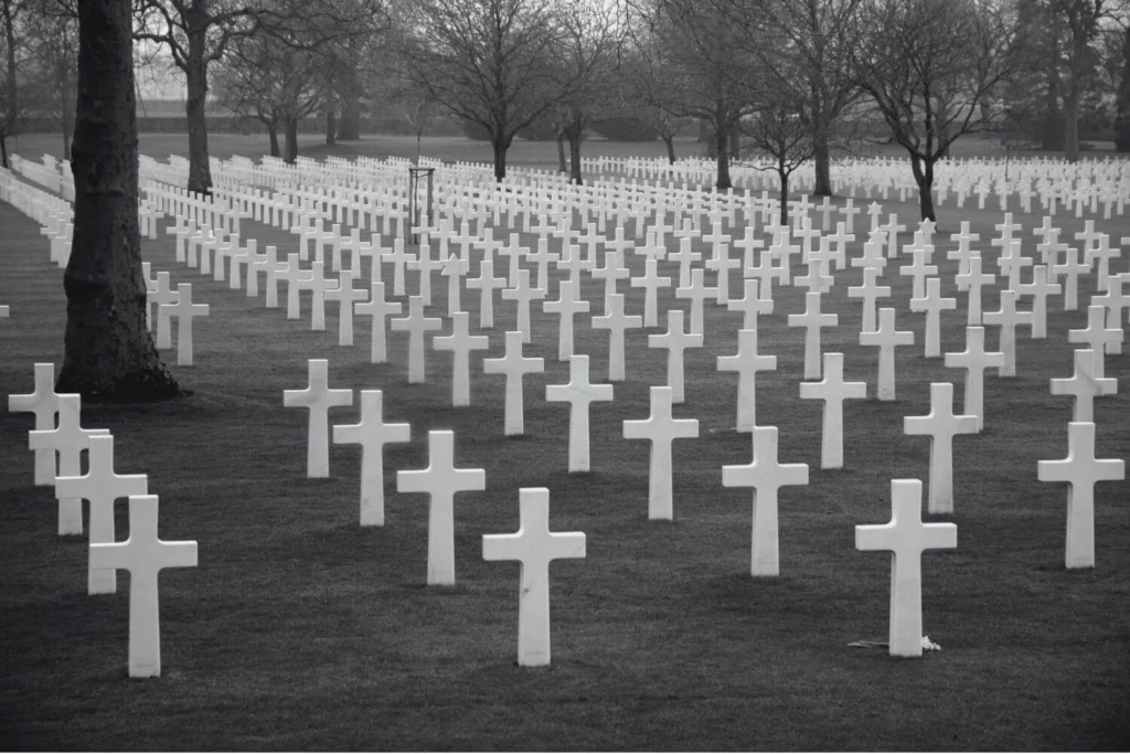 Rows of white crosses at an American military cemetery honoring soldiers who died defeating fascism during World War II.