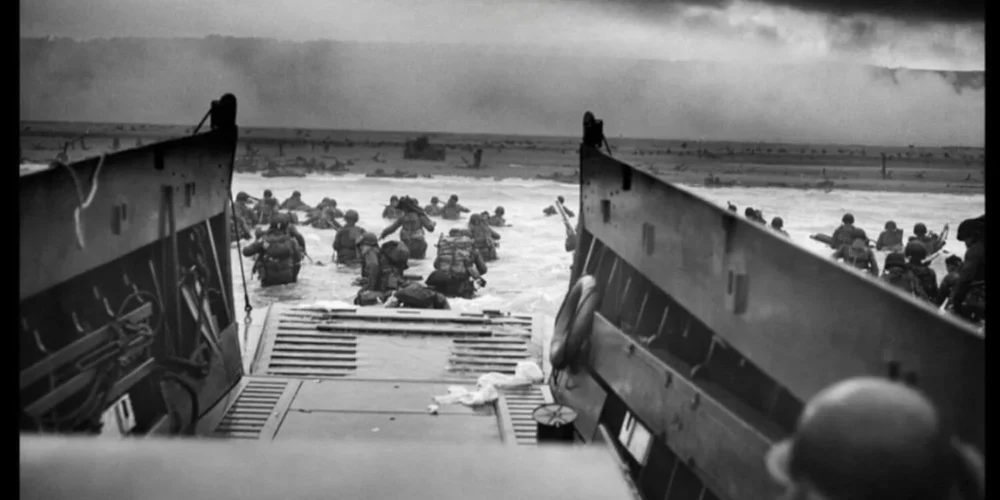 Allied soldiers wading ashore during the D-Day invasion highlighting the antifascist fight against Nazi Germany.