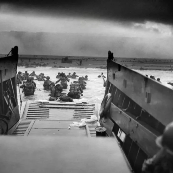 Allied soldiers wading ashore during the D-Day invasion highlighting the antifascist fight against Nazi Germany.
