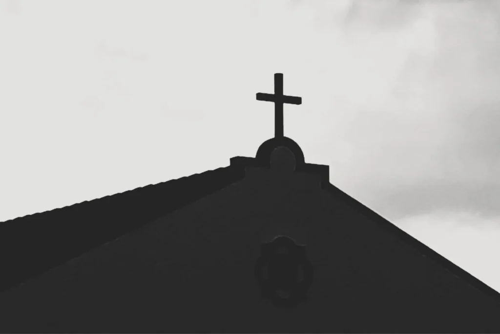 Black silhouette of a church cross highlighting the role of Christian symbolism in the evolution of white supremacy into Christian Nationalism.