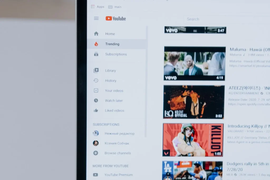 Close-up of the YouTube home screen showing trending videos and recommendation algorithms.