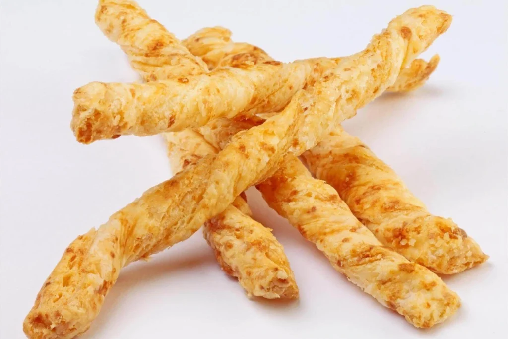 Flaky British cheese straws, a popular savoury Christmas snack served with drinks or cheese boards.