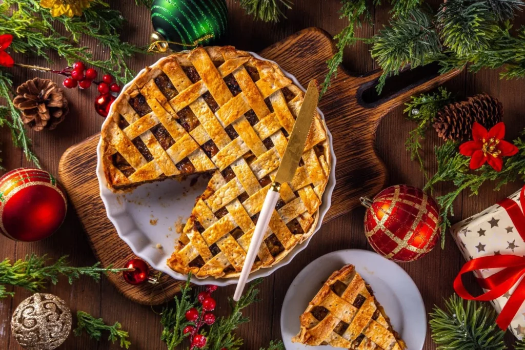Festive British Christmas pie with lattice pastry served on a wooden board.