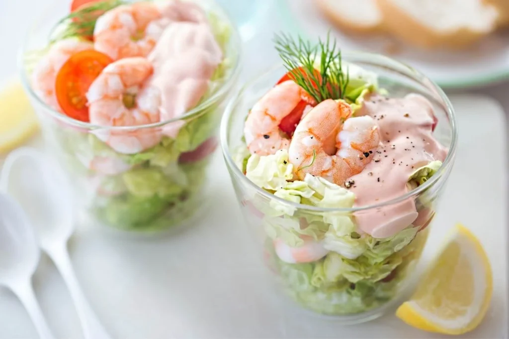 Classic British prawn cocktail served in glasses as a traditional Christmas starter or party appetizer. 