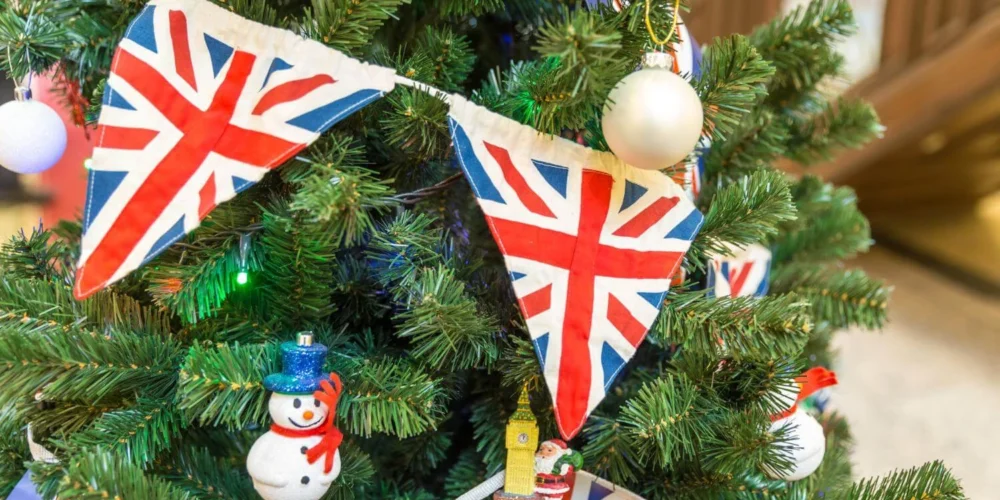British Christmas tree decorated with Union Jack bunting and festive ornaments, reflecting traditional British Christmas traditions.