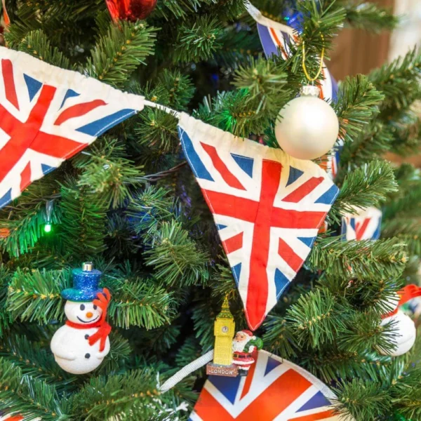 British Christmas tree decorated with Union Jack bunting and festive ornaments, reflecting traditional British Christmas traditions.