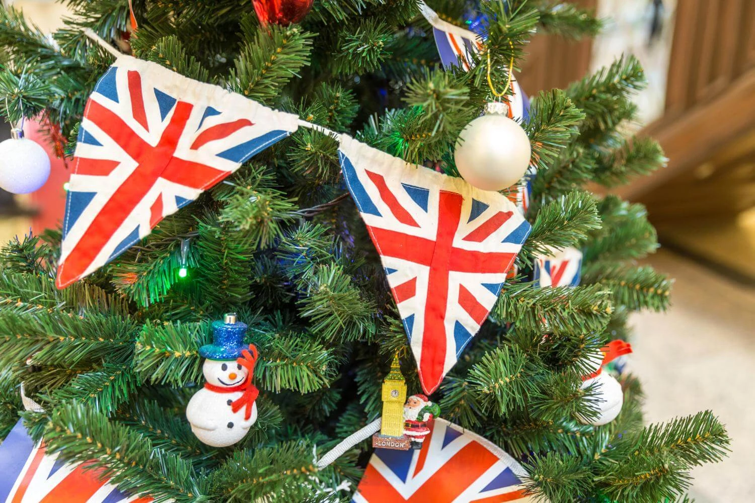 British Christmas tree decorated with Union Jack bunting and festive ornaments, reflecting traditional British Christmas traditions.