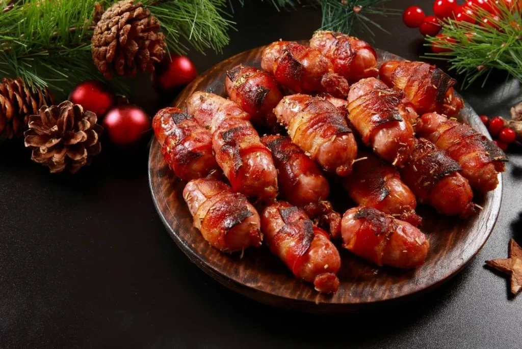 British pigs in blankets wrapped in bacon, served as a classic Christmas appetiser.