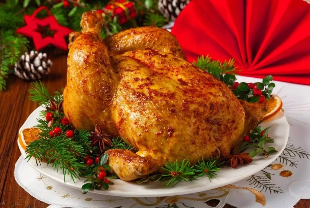 British-style roast chicken served for Christmas dinner with festive garnishes. 