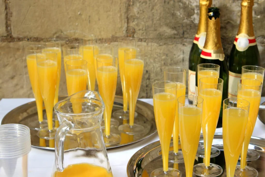 Bucks Fizz made with champagne and orange juice served in tall flutes at Christmas time.