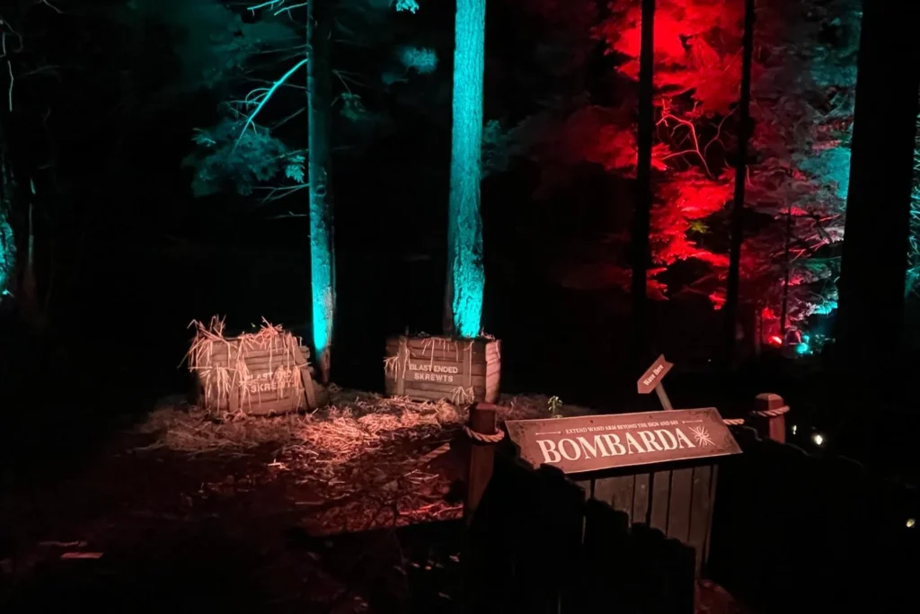 A Bombarda spell casting station beside crates labeled Blast-Ended Skrewts at the Harry Potter Forbidden Forest Experience.