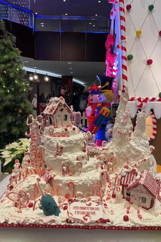 Festive Gingerbread Lane display at the Hyatt Regency Vancouver featuring a large candy cane mountain scene with icing trees, peppermint decorations, and a small gingerbread house.