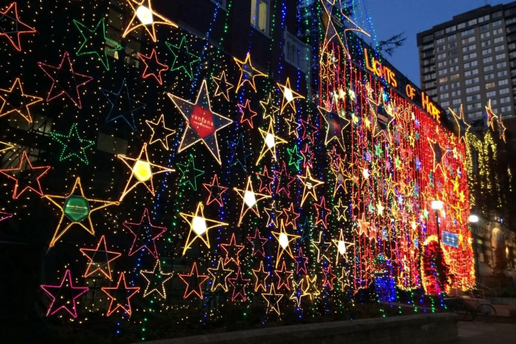 Colorful star-shaped light decorations cover the exterior of St. Paul's Hospital in Vancouver as part of the annual Lights of Hope charity display.