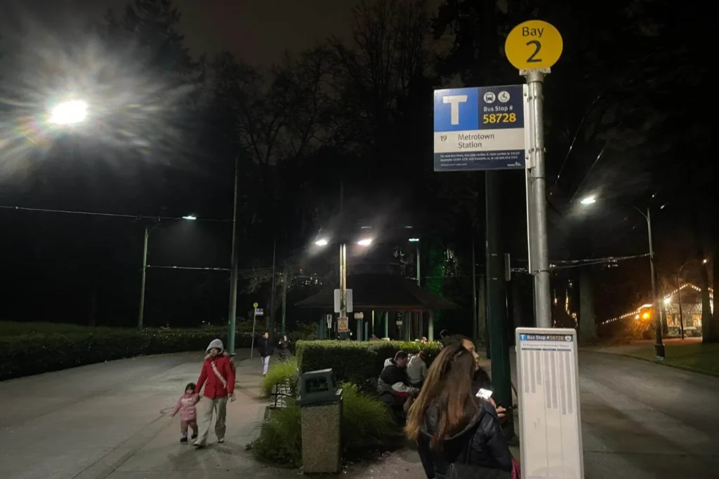 Bus stop at Bay 2 of Stanley Park bus loop for Metrotown Station at night, showing one of the main transit pickup points for the Harry Potter Forbidden Forest Experience.