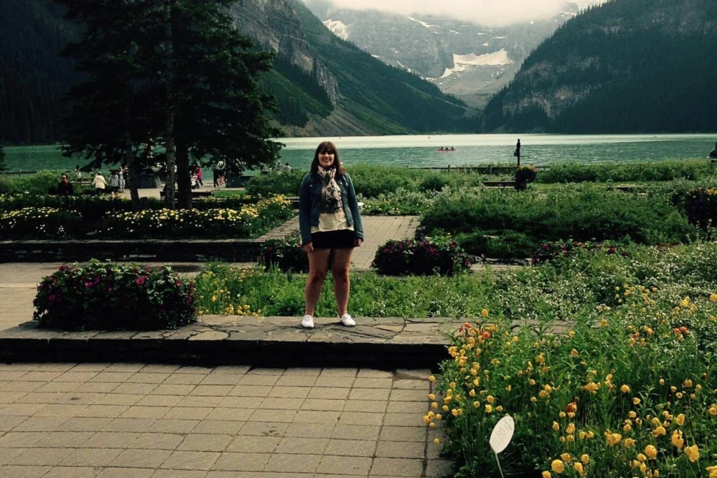 Female solo traveler exploring Lake Louise in Canada, representing confidence and independence gained through solo travel.